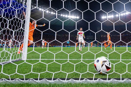Wout Weghorst of Netherlands and Hakan Calhanoglu of Turkey