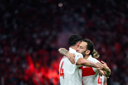 Samet Akaydin and Hakan Calhanoglu of Turkey celebrates
