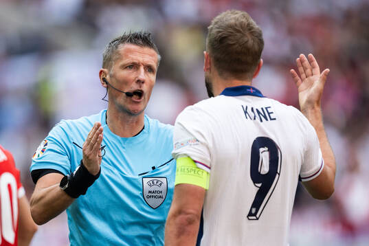 Referee Daniele Orsato with Harry Kane of England