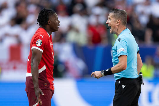Breel Embolo of Switzerland and referee Daniele Orsato