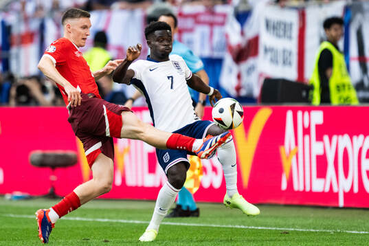 Michel Aebischer of Switzerland and Bukayo Saka of England
