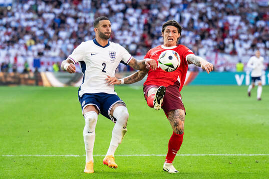 Kyle Walker of England and Steven Zuber of Switzerland
