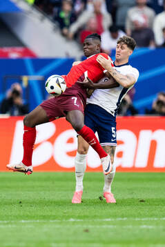 Breel Embolo of Switzerland and John Stones of England