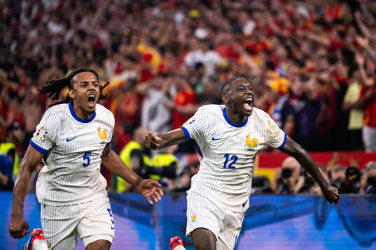 Jules Koundé and Randal Kolo Muani of France celebrate