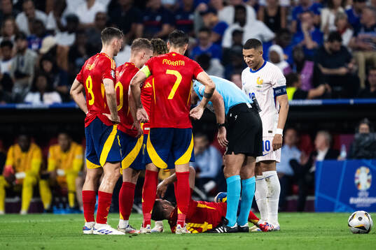 Daniel Vivian of Spain in pain and Kylian Mbappé of France
