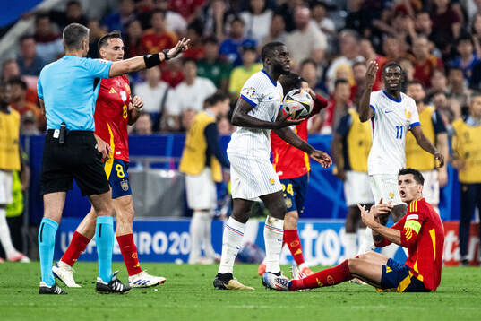 Dayot Upamecano of France and Alvaro Morata of Spain reacts