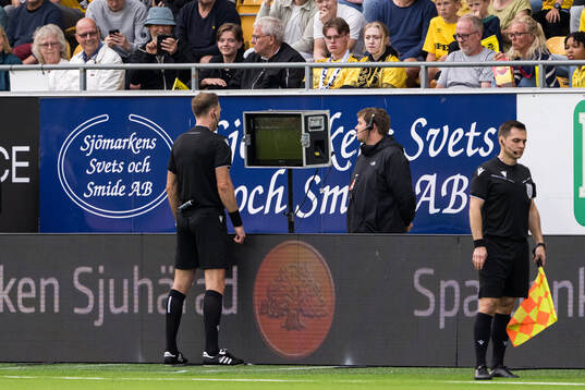 Referee Dmytro Panchyshyn checking the VAR monitor