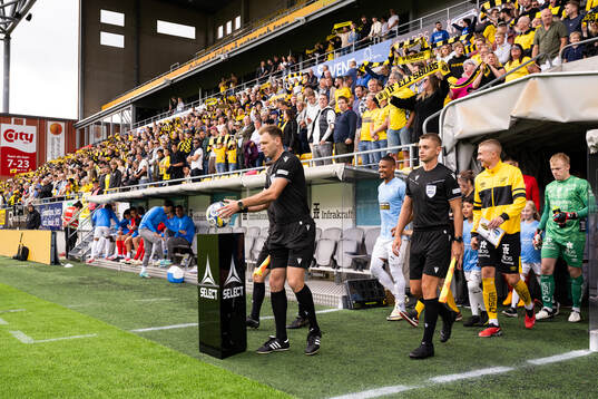 Referees and players enter the field