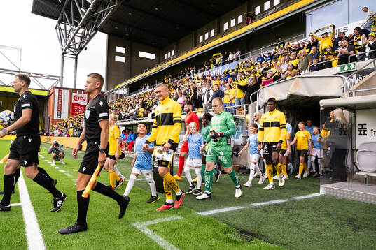 Referees and players enter the field