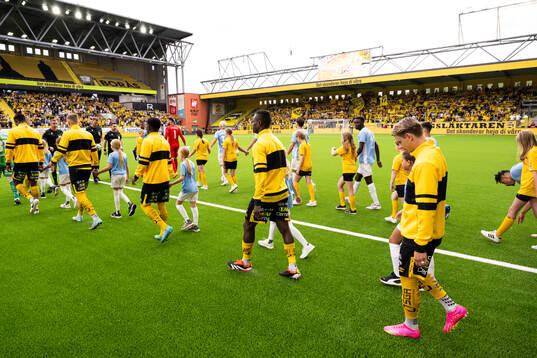 Referees and players enter the field