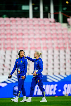 Rusul Rosa Kafaji and Anna Sandberg of Sweden walks the