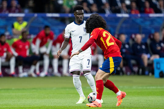 Bukayo Saka of England and Marc Cucurella of Spain