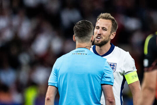 Harry Kane of England talks to referee Francois Letexier