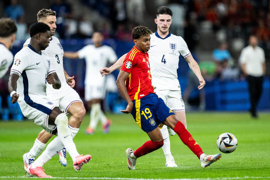 Lamine Yamal of Spain against Marc Guehi, Luke Shaw and