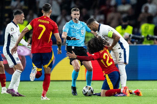 Referee Francois Letexier against Marc Cucurella of Spain