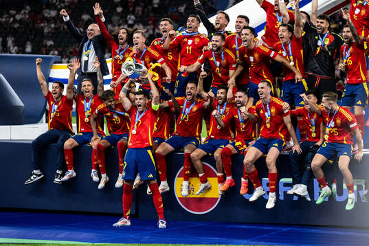Alvaro Morata of Spain celebrates with team mates and the