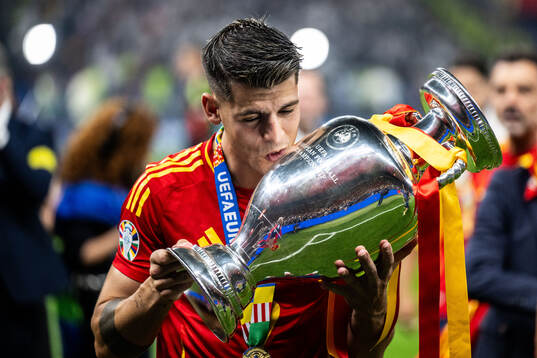 Alvaro Morata of Spain celebrates with the trophy