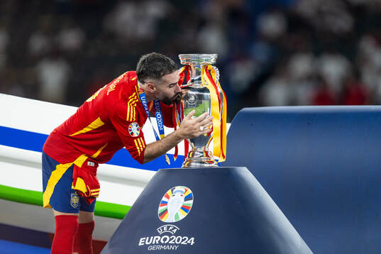 Daniel Carvajal of Spain kisses the trophy as he celebrats