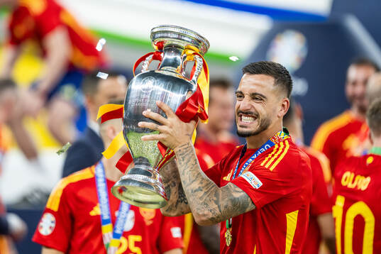 Joselu of Spain celebrates with the trophy