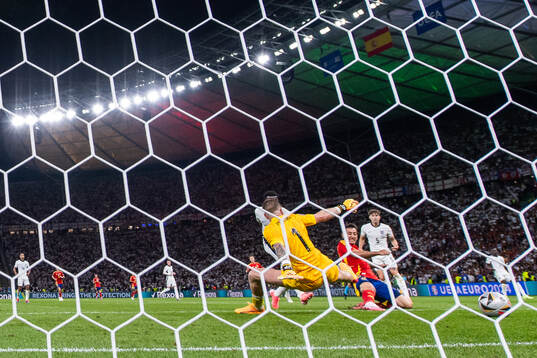 Mikel Oyarzabal of Spain scores 2-1 behind goalkeeper