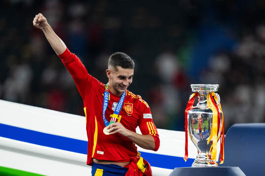 Ferran Torres of Spain celebrates next to the trophy