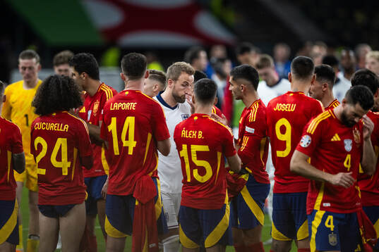 Harry Kane of England looks dejected as he walks past