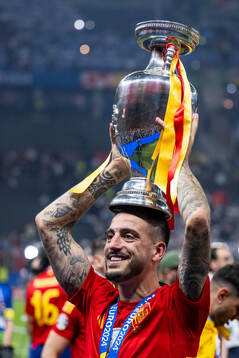Joselu of Spain celebrates with the trophy