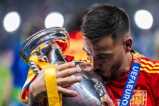 Joselu of Spain celebrates with the trophy