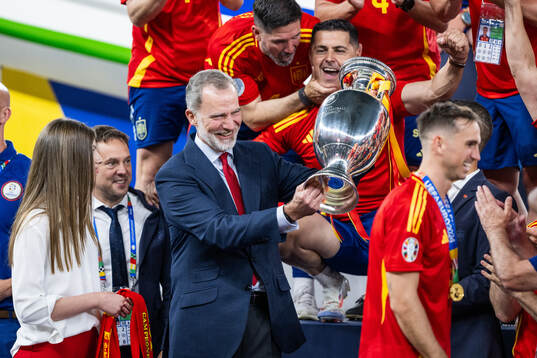 King Felipe VI of Spain celebrates with the trophy