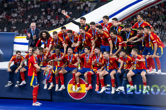 Alvaro Morata of Spain celebrates with the trophy in front
