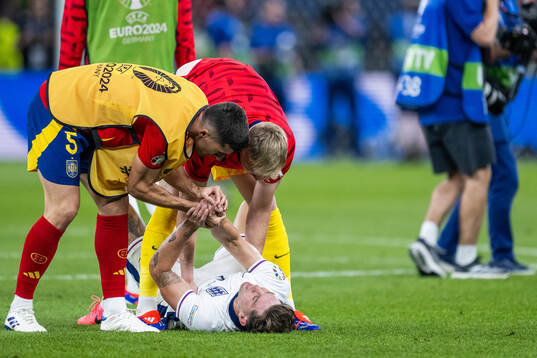 Daniel Vivian of Spain comforts John Stones of England who