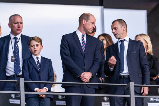 Prince George and Prince William of Great Britain stand