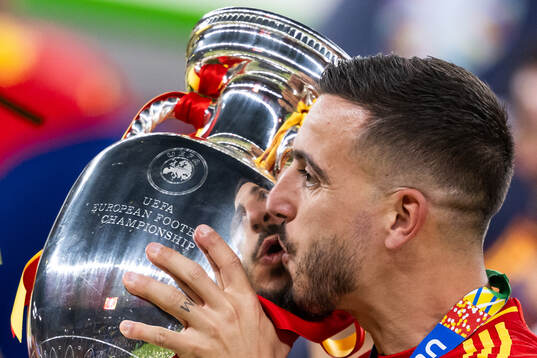 Joselu of Spain celebrates with the trophy