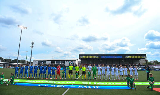 Players of both sides line up