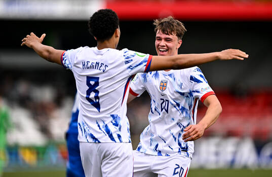 Daniel Braut of Norway celebrates with teammate Travis
