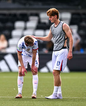 Rasmus Holten, left, is consoled by Norway teammate Håkon