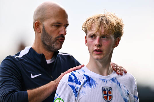 Sondre Granaas of Norway is consoled by Norway head coach