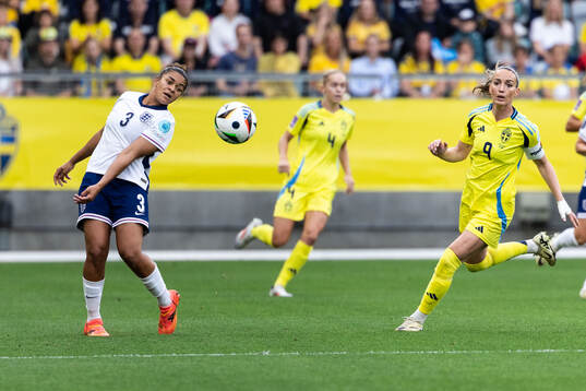 Jessica Carter of England and Kosovare Asllani of Sweden