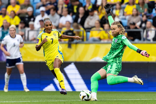 Madelen Janogy of Sweden and goalkeeper Hannah Hampton of