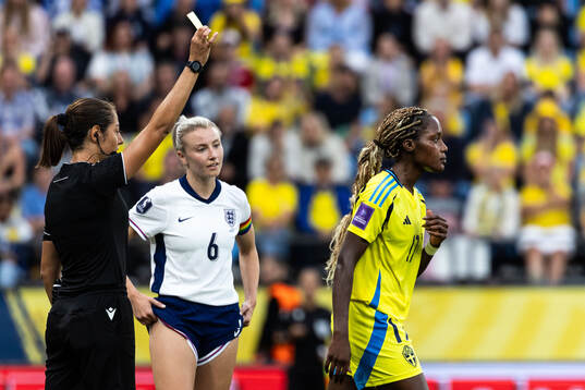 Evelyn Ijeh of Sweden receives a yellow card from Referee