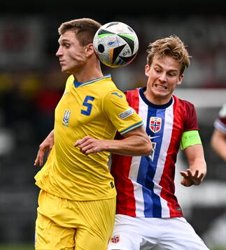Mykola Oharkov of Ukraine is tackled by Benjamin Thoresen