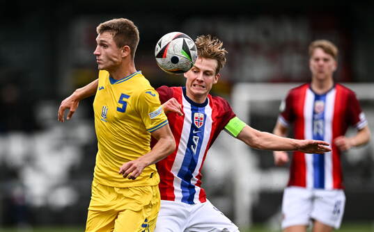 Mykola Oharkov of Ukraine is tackled by Benjamin Thoresen