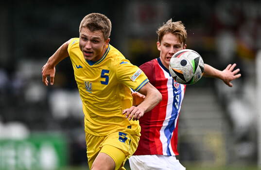 Mykola Oharkov of Ukraine is tackled by Benjamin Thoresen