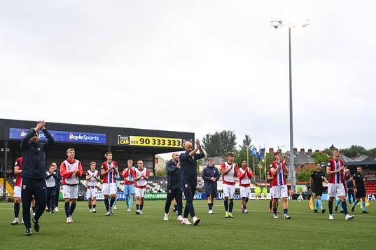 Norway players and staff applaud toward the travelling