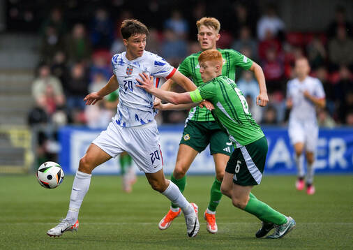 Daniel Braut of Norway is tackled by Gallagher Lennon of