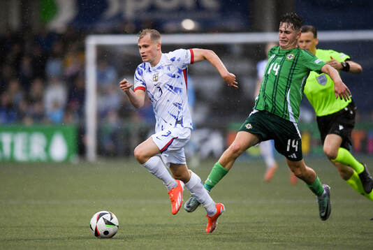 Alexander Andresen of Norway is tackled by Jack Doherty of