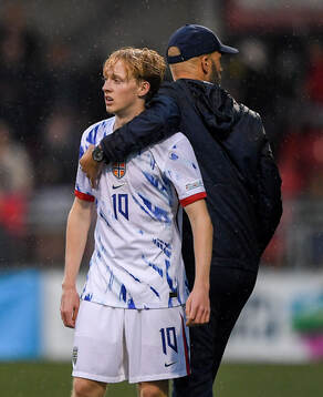 Sondre Granaas of Norway is hugged by head coach Luis
