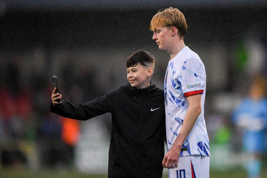 Sondre Granaas of Norway takes a selfie with a supporter