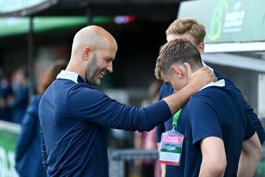 Norway head coach Luis Pimenta shares a joke with a member