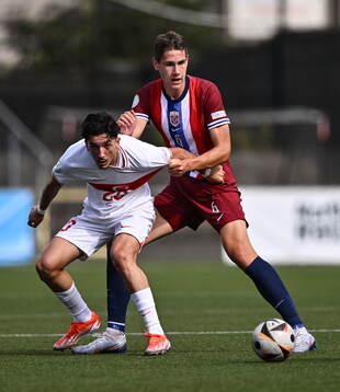 Emre Uzun of Turkiye in action against Eivind Helland of